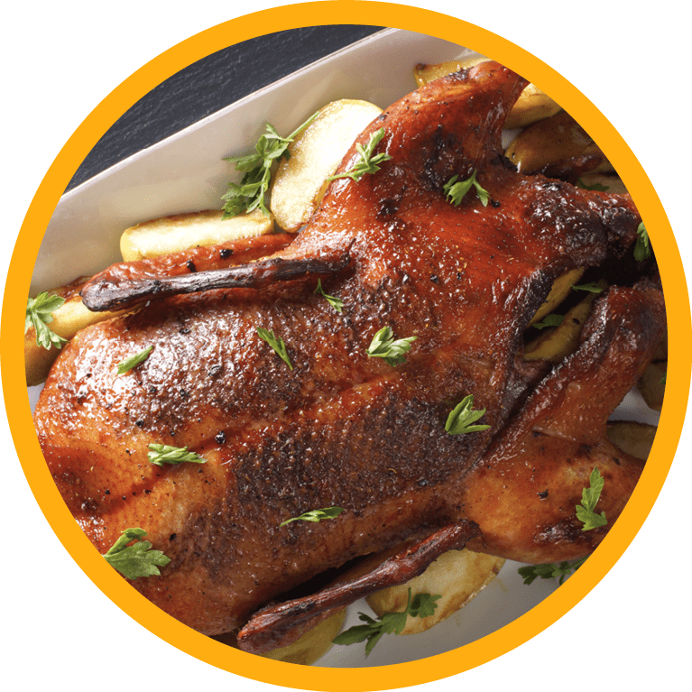 Delicious whole baked duck with apples close-up on a platter on the table. horizontal view from above 